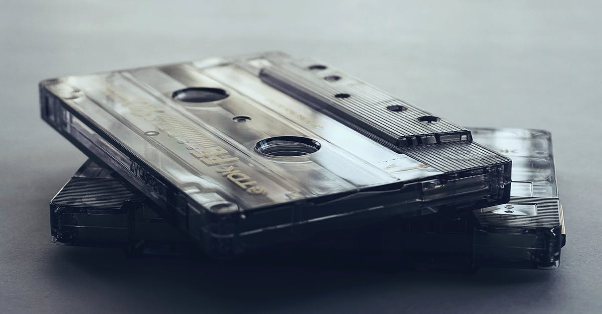 80s / 90s Sci Fi movie or show about aliens/monster that look amish [closed] - Close-Up Photo of Cassette Tapes