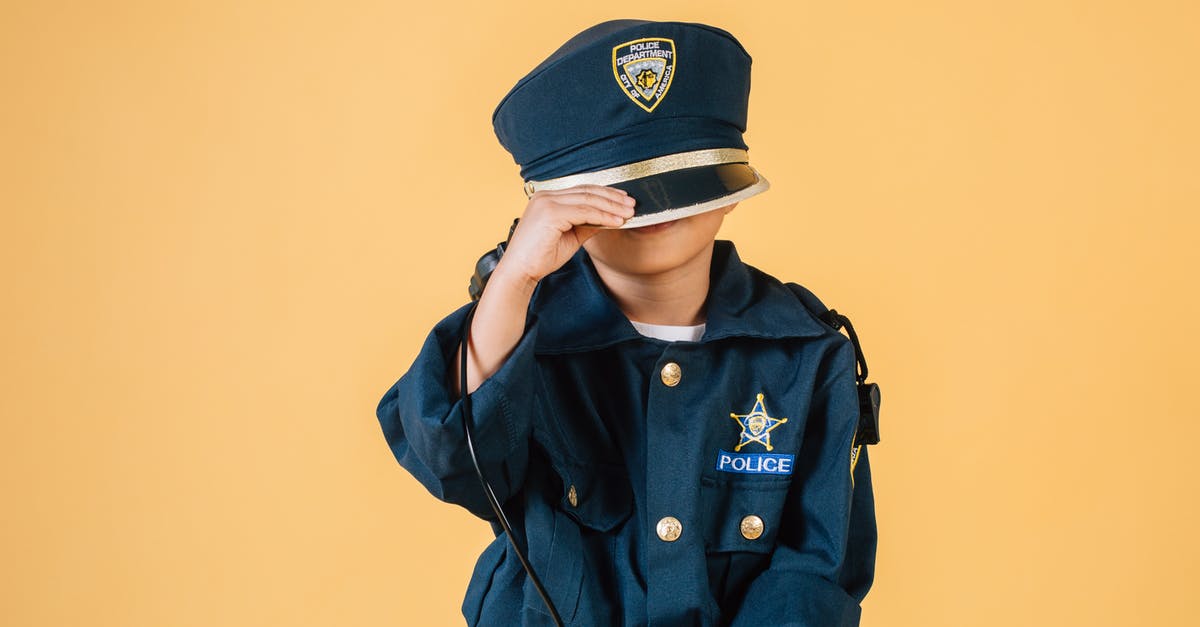 90s Prostitute reference in Law & Order: SVU - Unrecognizable child in police uniform standing in studio with transceiver in hand and pulling cap over face on yellow background