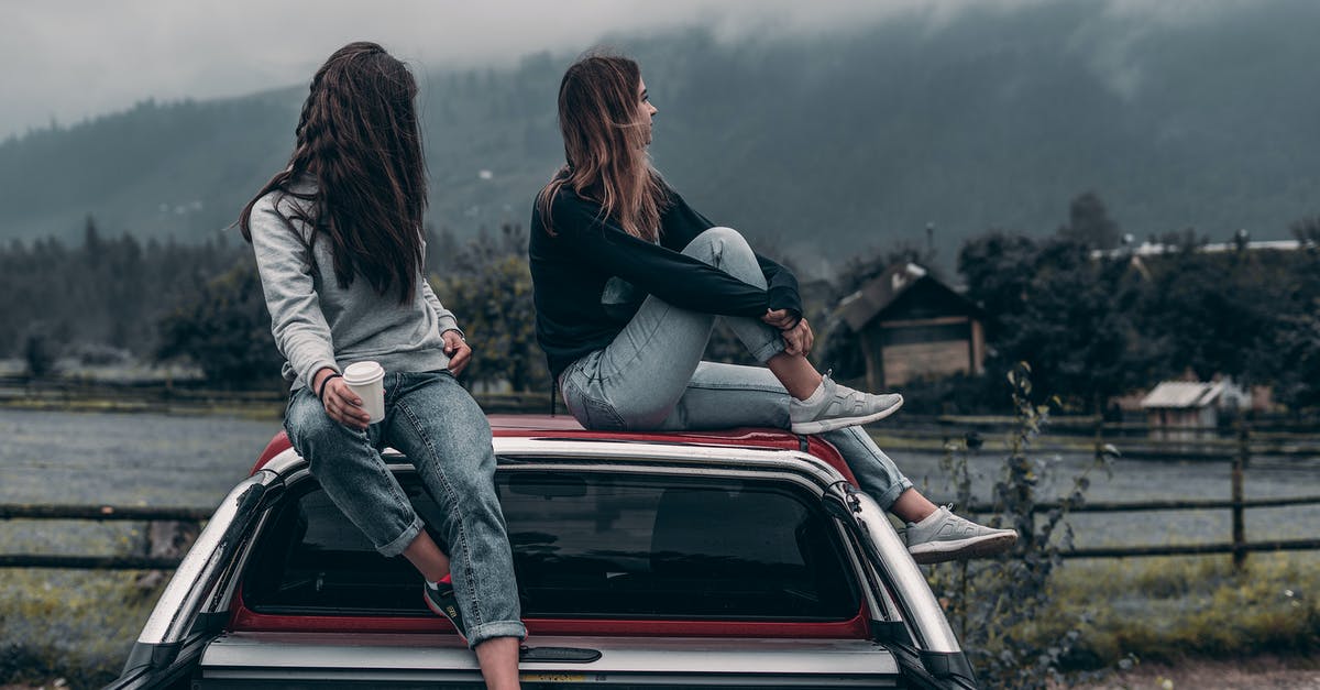 A civilian for two weeks? - Two Women Sitting on Vehicle Roofs