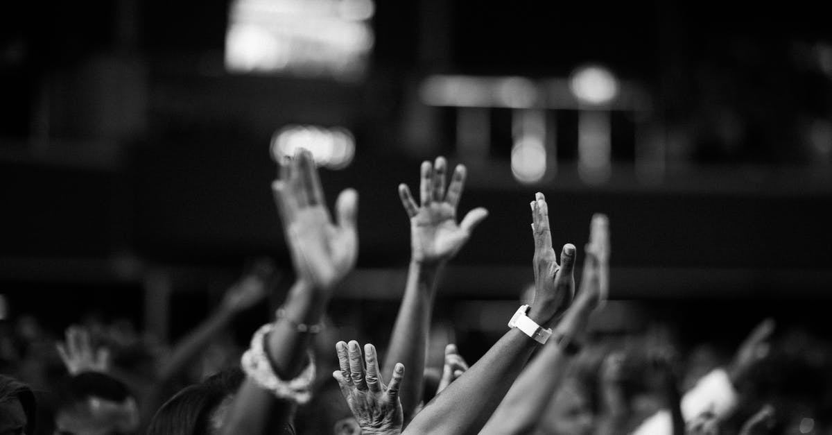 After being rescued from captivity by Walt, why doesn't Jesse immediately surrender to the police? - Grayscale Photography of People Raising Hands