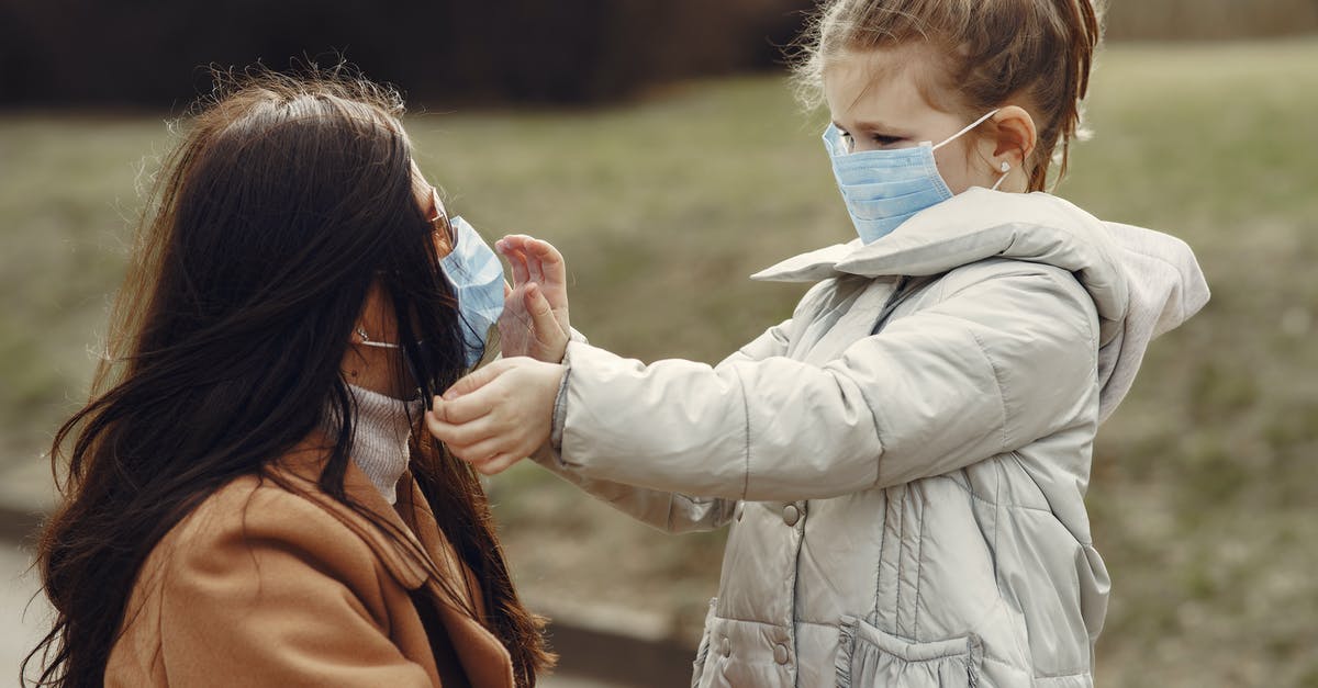 After the Time of the Doctor are the events in the Name of the Doctor just an aborted timeline? - Cute little girl in mask helping put on medical mask for mom in sunglasses during stroll in park