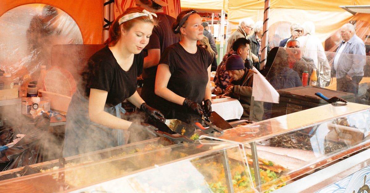 Aliens and vampires don't sell? - Women in Black Shirt Selling Food in Food Stall