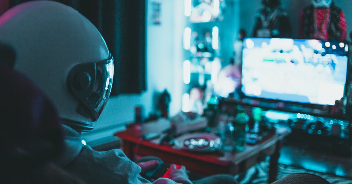 Any known cases of a person appearing in one reality TV show as having one career but later in another reality TV show as having a different career? - Side view of unrecognizable person in virtual reality helmet sitting on sofa and playing with gamepad in dark room