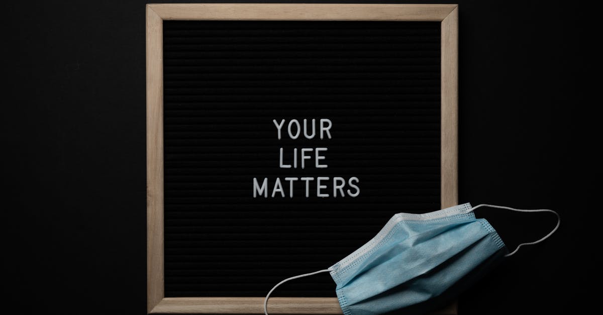 Aphorisms and idioms in The Witcher - Overhead arrangement of framed black photo with white words Your Life Matters on black background near medical mask