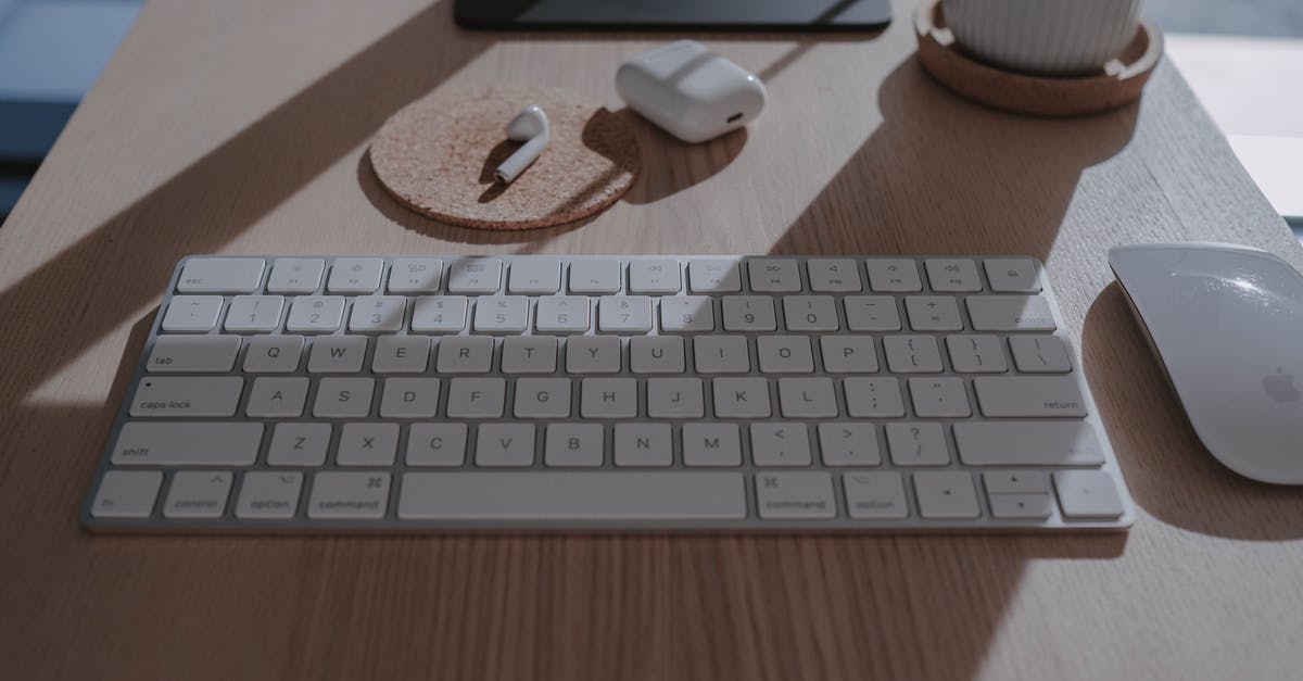 Apple products in movies - A Keyboard, Mouse and Wireless Headphones on a Wooden Table Top