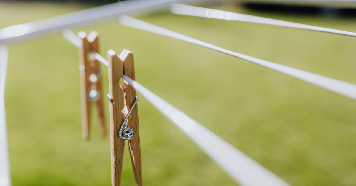 Are all Pixar movies set in the same universe? - Composition of wooden clothespins hanging on collapsible clotheshorse placed on green lawn in garden on sunny day
