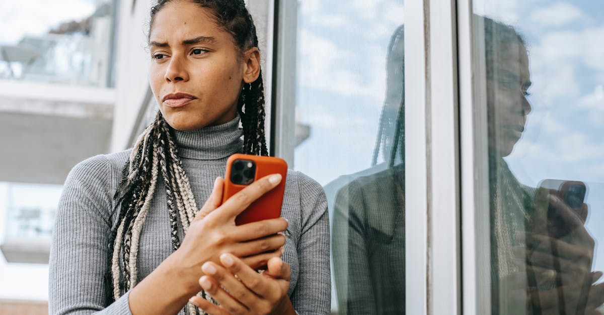 Are any of the questions in Michael's test valid reasons for being sent to the Bad Place? - Low angle of concerned ethnic female with smartphone in stressful situation near glass wall