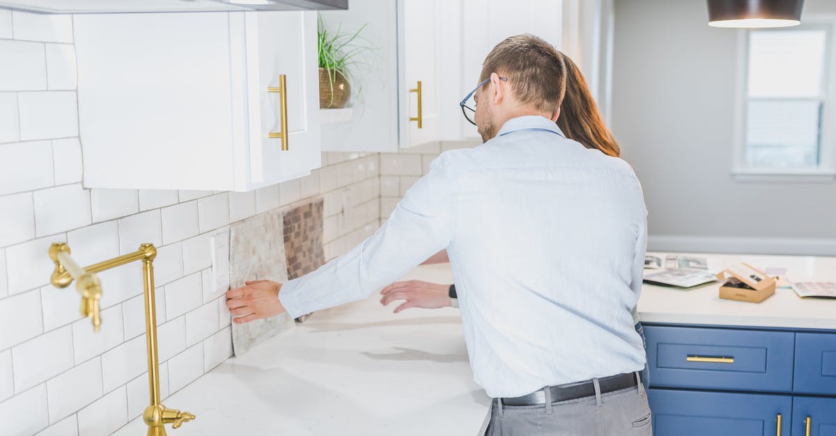 Are Attorney General Special Agents real? - Real Estate Agents Checking the Tiles in the Kitchen
