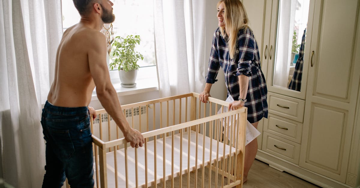 Are newborn babies infected? - Happy Couple Assembling Baby Crib at Home