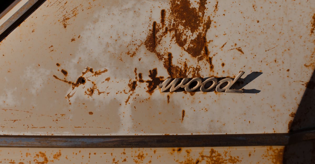 Are the brands worn by the stars in a movie part of promotions? - Corroded stains on part of old automobile with fragment of brand name written by metal letters