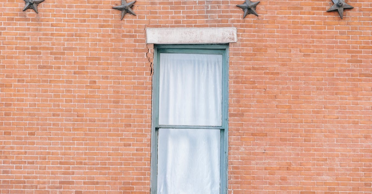 Are the brands worn by the stars in a movie part of promotions? - Exterior of aged red brick building with curtained window and star shaped decoration