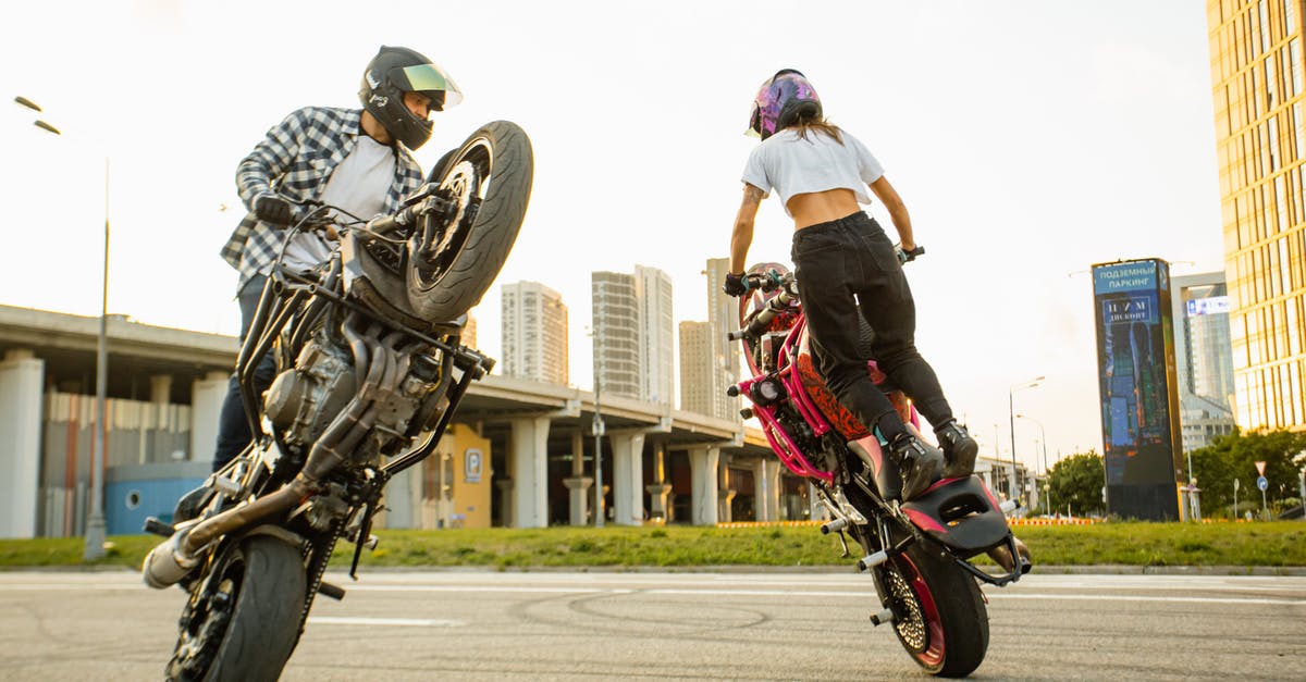 Are the stunts staged or spontaneous? - Man and Woman Riding on Motorbikes Doing Stunt 