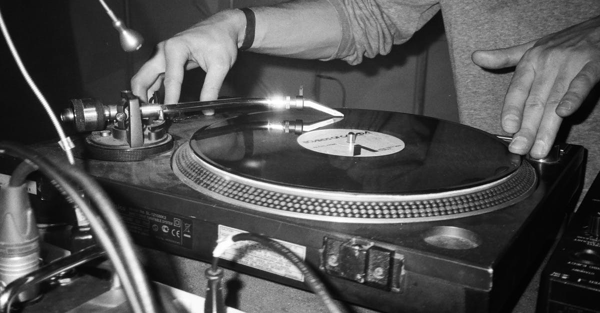 Are there no written records of Spider-Man's identity? - Grayscale Photography of Person Playing Turntable