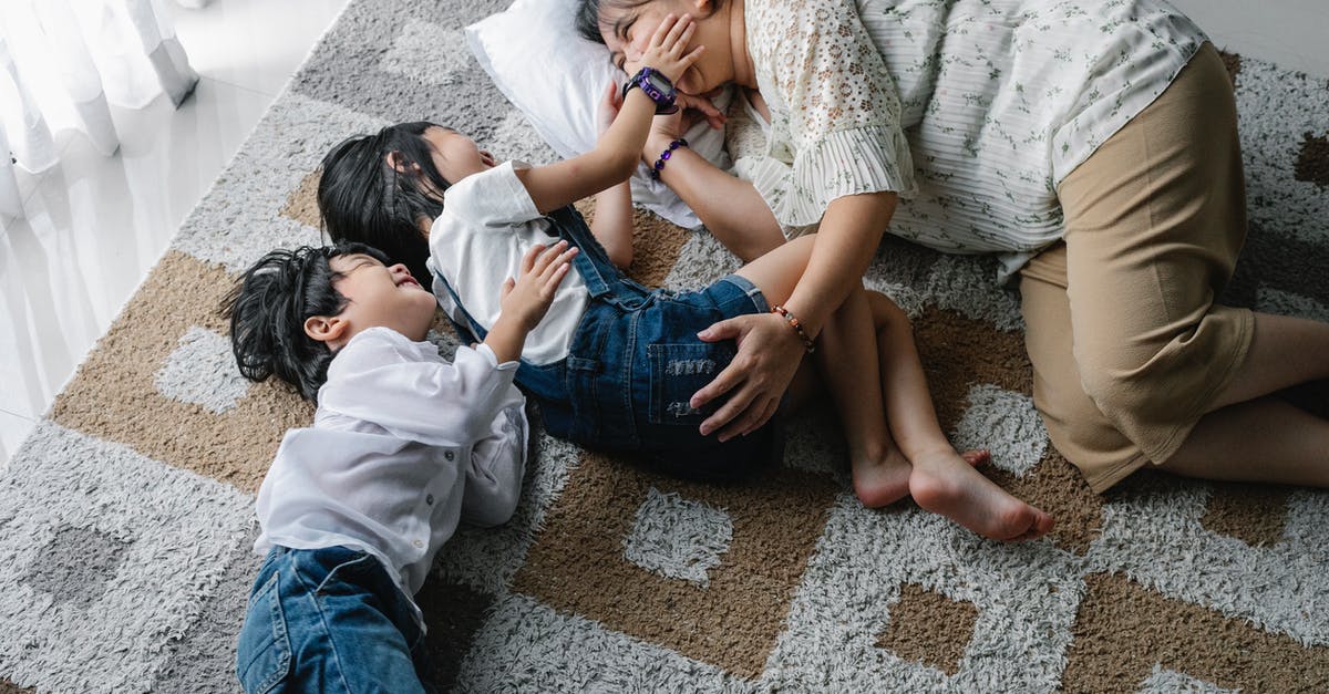 Are there scenes missing from the home versions related to Marie Kreutz? - From above of happy kids lying on carpet on soft carpet with mother and spending time together