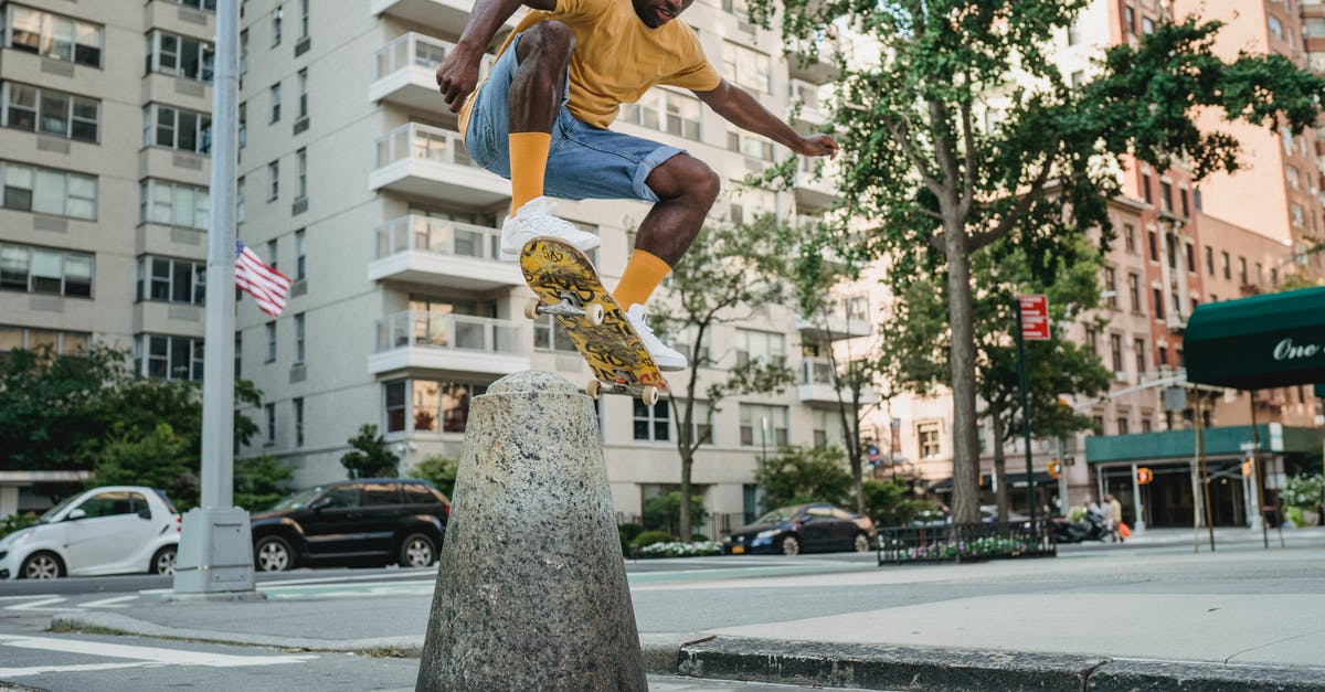 Are there union rules requiring stunt performers, and what does this mean for action stars who "do their own stunts"? - Full body athletic African American male skater in summer wear jumping on skateboard on urban street