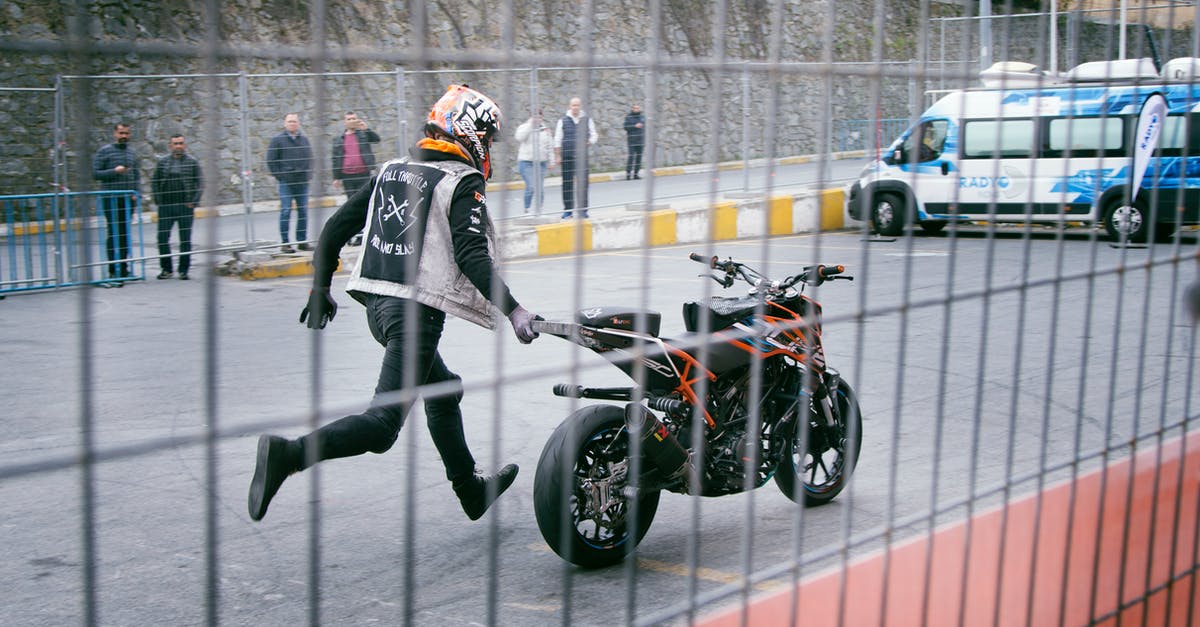 Are there union rules requiring stunt performers, and what does this mean for action stars who "do their own stunts"? - Man Holding Orange and Black Sports Bike on Asphalt Road