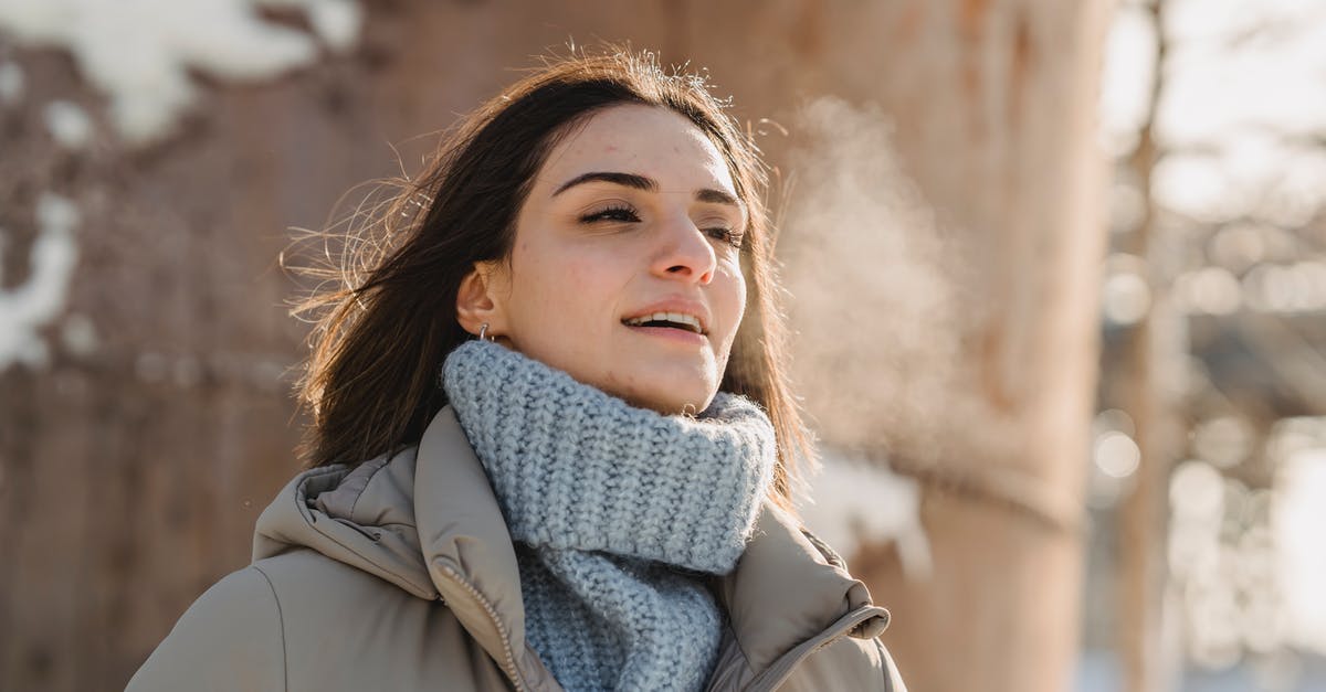 Are they breathing air in Matrix? - Young woman exhaling steam on freezing cold weather