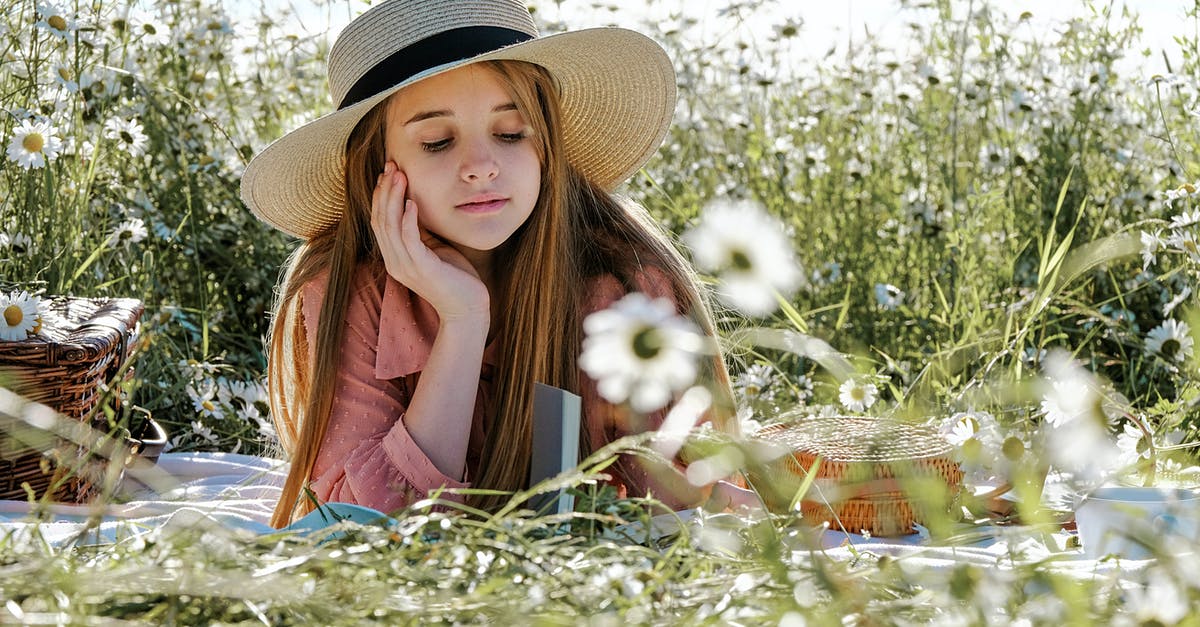 At which dream level did Inception end? - Pensive adolescent in hat with long straight sandy hair looking down while chilling in field in summertime in sunlight
