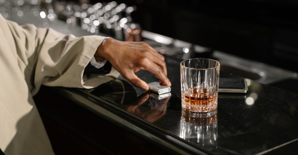 Breaking a whiskey glass with your bare hands: how would this have been done? - Photo of Glass on Top of Counter