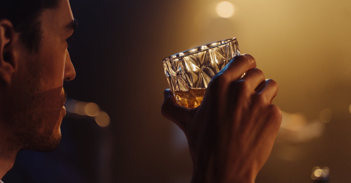 Breaking a whiskey glass with your bare hands: how would this have been done? - Selective Focus Photo of a Man Holding a Glass of Whisky