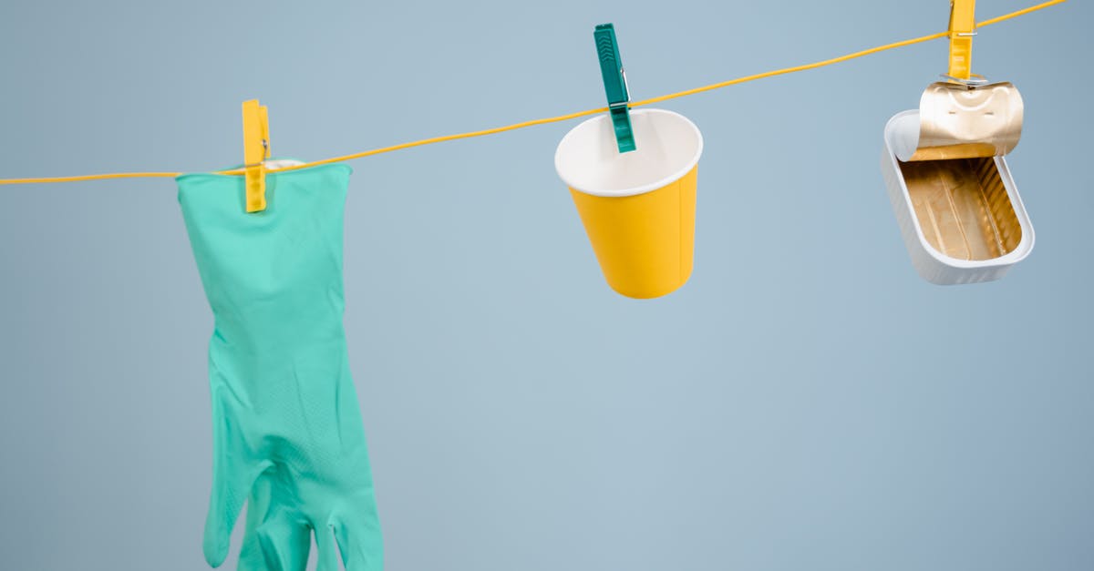 Can Aliens see cloaked predators? - Teal Rubber Gloves Hanging Beside Yellow Cup and Can