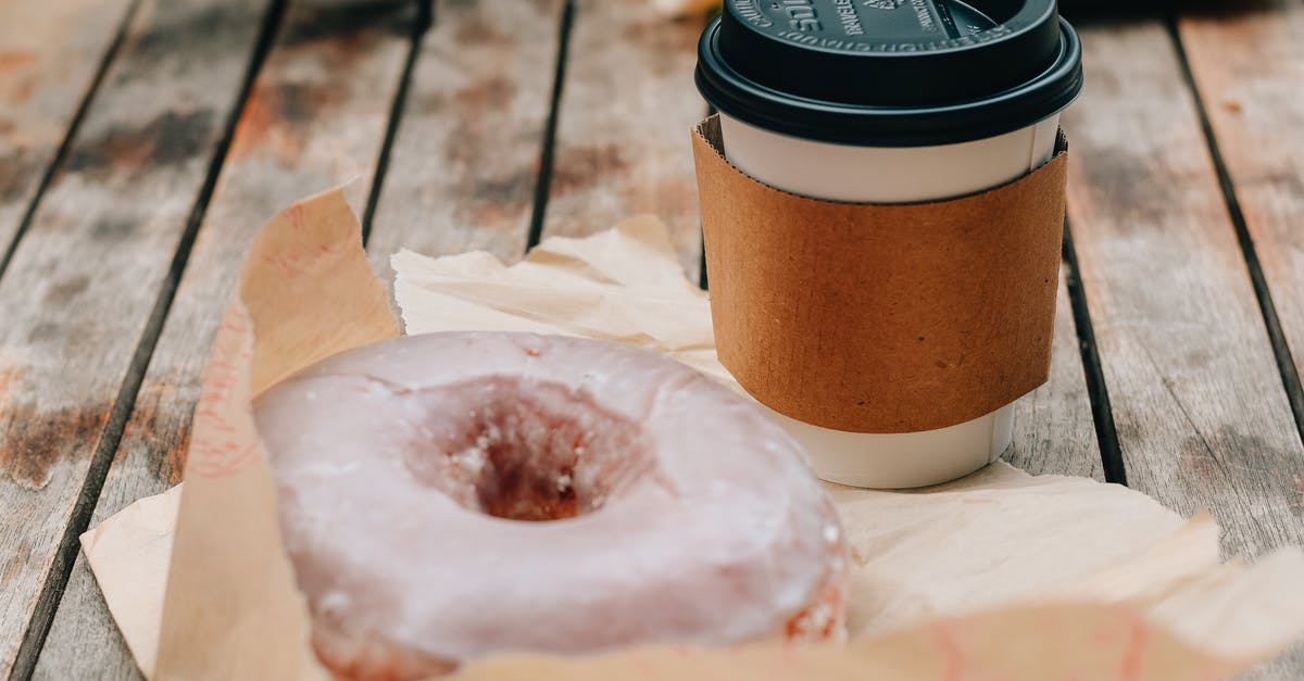 Can Product Placement in Movies break the 4th Wall? - Tasty sweet chocolate donut and takeaway cup of coffee placed on wooden surface in daytime