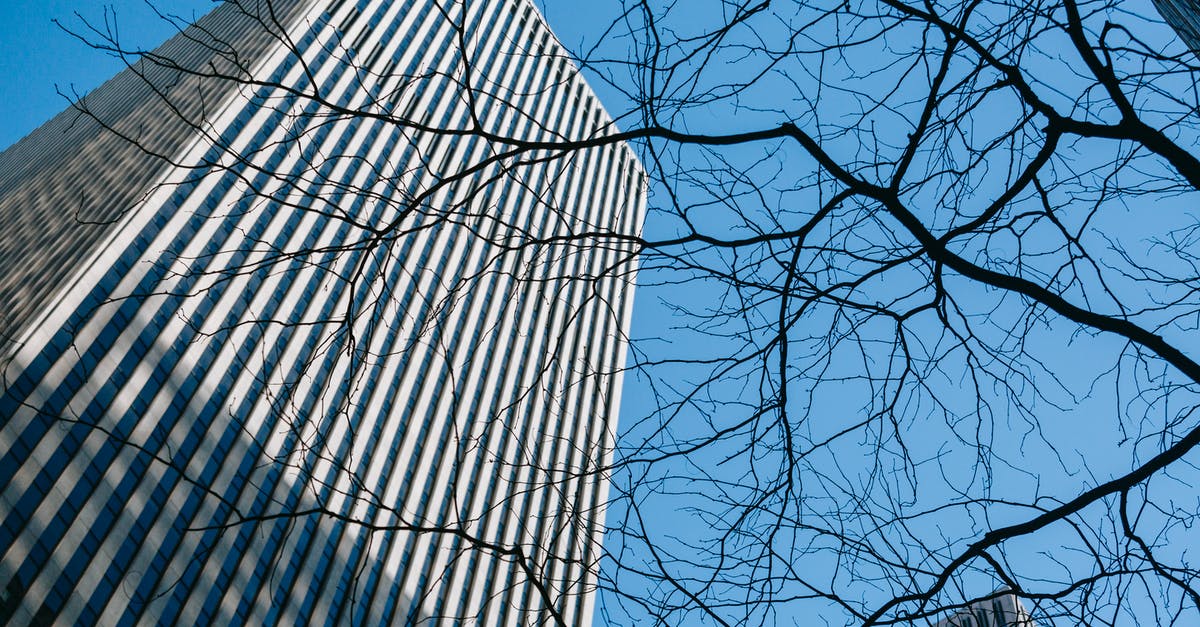 Can someone explain how Kat experienced this part of Tenet from her perspective? - From below of gray modern tall building of business center under bright cloudless blue sky