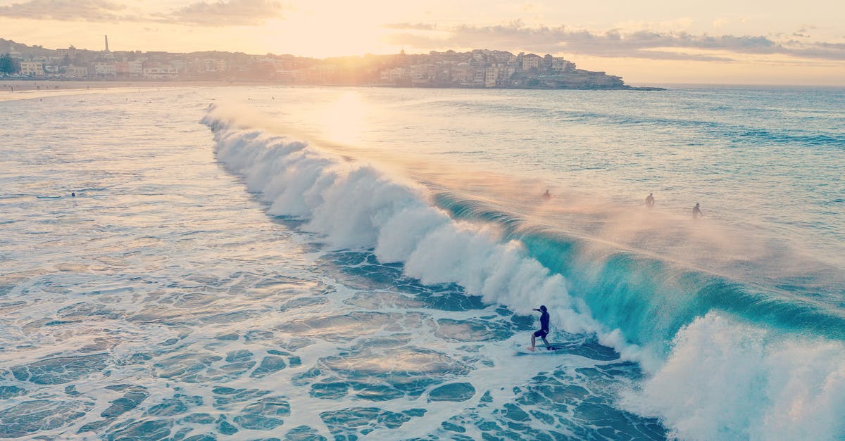 Can there be sunlight in Australia and Texas at the same time? - Photo of Man Surfing on Ocean Waves