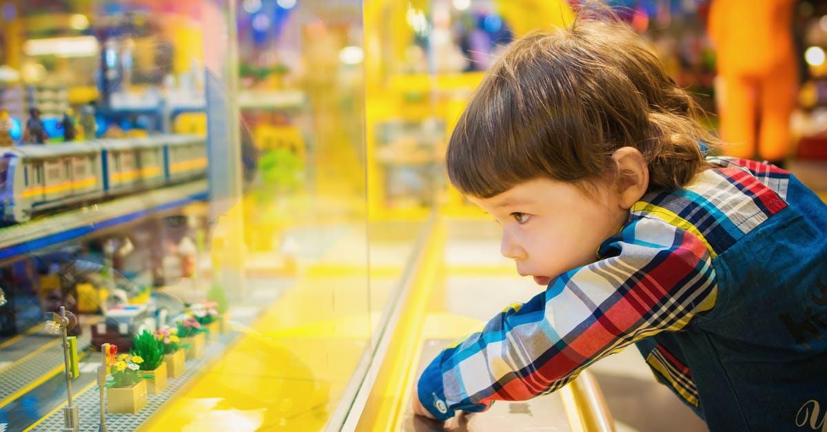 Christmassy movie about a rat in a toy store [closed] - Selective Focus Photography of Toddler in Front of Glass