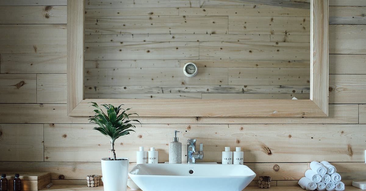Clear references in 'This Is Spinal Tap' - Stylish interior design of contemporary bathroom with wooden walls and big mirror above sink and table with toiletries