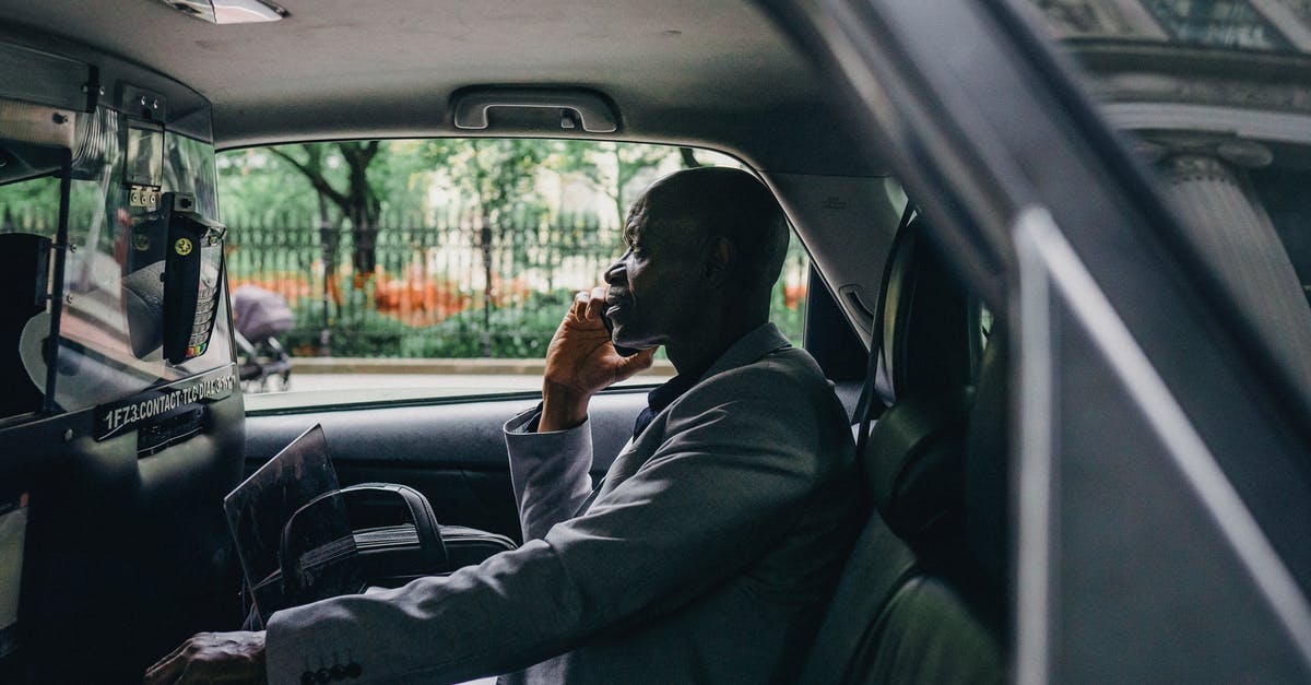 Crew try to make contact with an intelligent storm [closed] - Side view of African American male discussing strategy on mobile phone in automobile