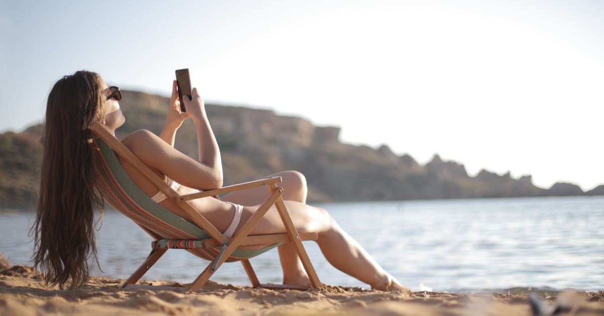 Danny Ocean using Guns - Woman in White Bikini Reclining on Wooden Folding Beach Chair