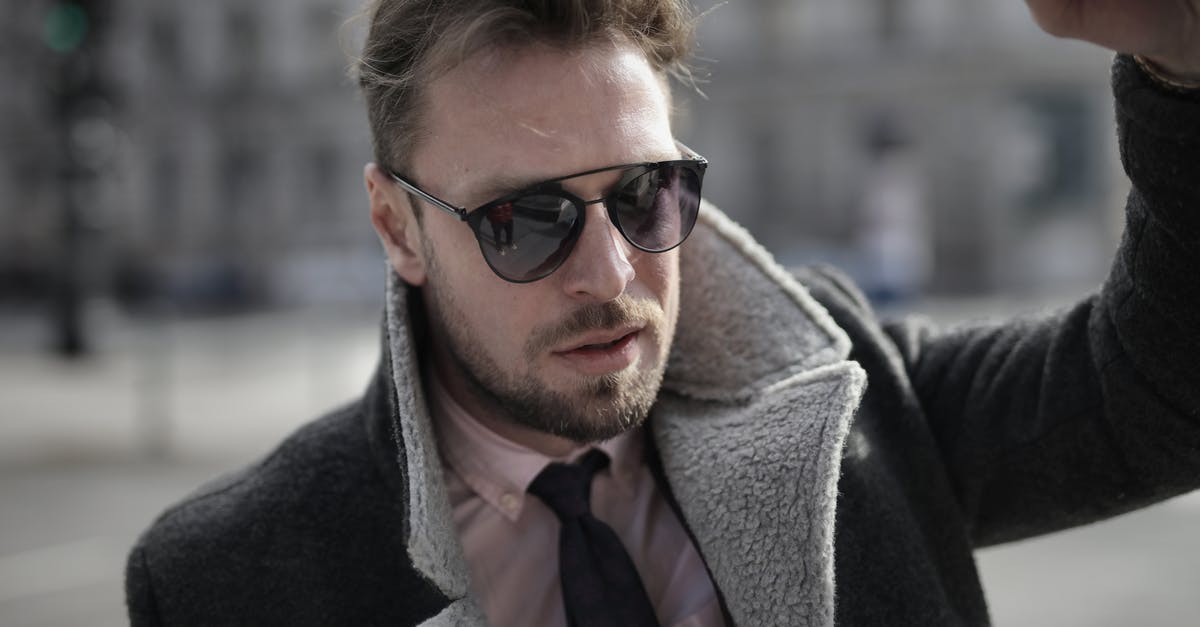 Determine original language of the movie - Confident stylish man on city street