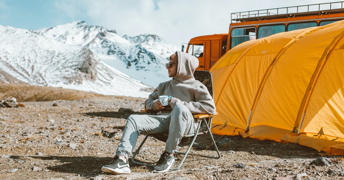 Did Andy Dufresne use more than one rock hammer to escape from Shawshank? - Full length of male camper sitting on folding chair next to tent in middle of mountain valley and enjoying views