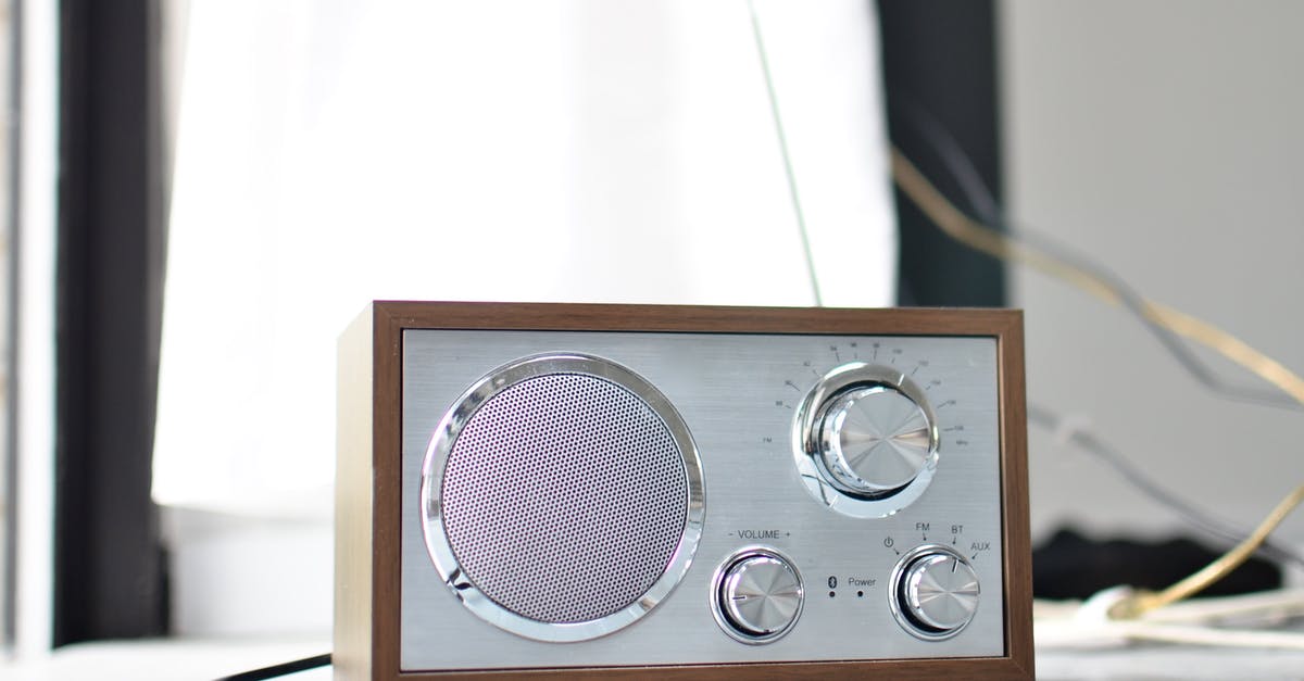 Did Brazil carry a disclaimer about its uncomfortably loud volume? - Classic styled radio receiver with chrome buttons and speaker and wooden case placed on table in daylight