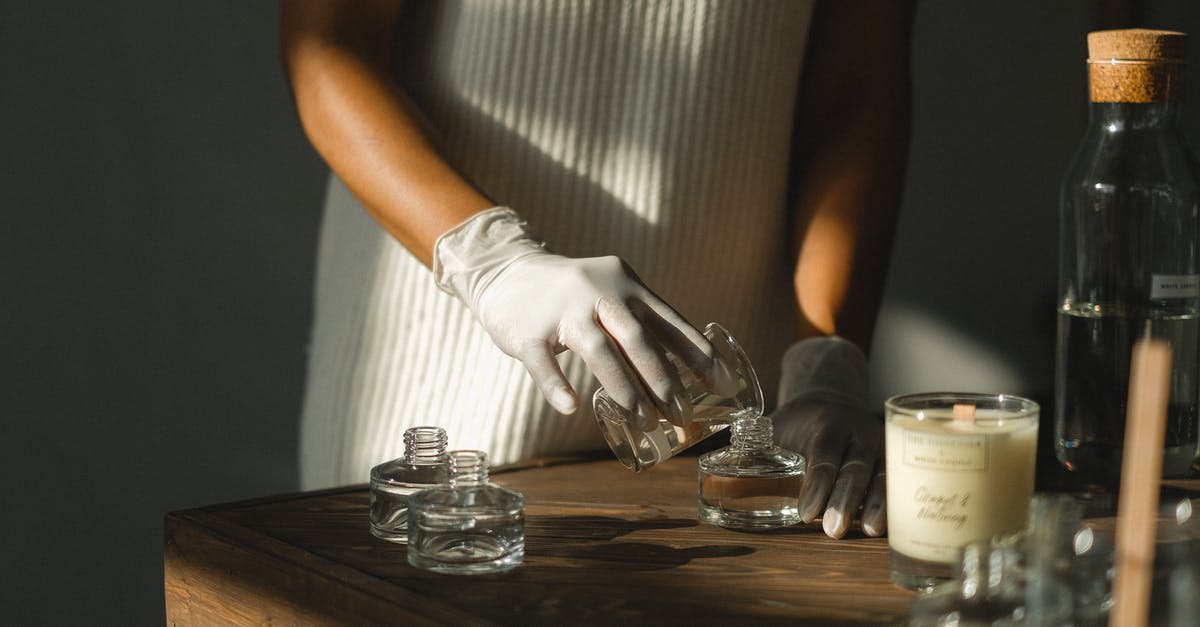 Did Krennic make a calculated error? - Unrecognizable crop African American female pouring essential oil in glass bottle while making liquid incense at table