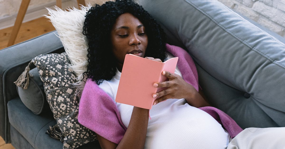 Did Magneto ever actually expect to commit genocide in X2? - From above of focused pregnant African American female taking notes in notepad while resting on comfortable sofa in living room