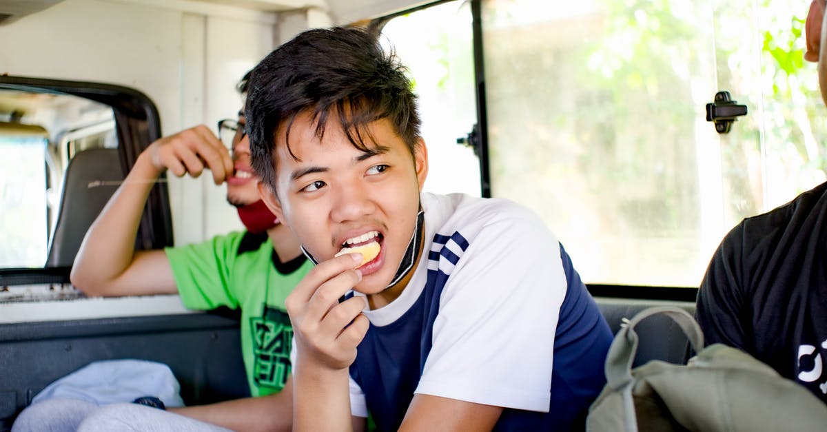 Did the kid on the bus know that Peter is Spider-Man? - Young ethnic boy eating cookie in bus