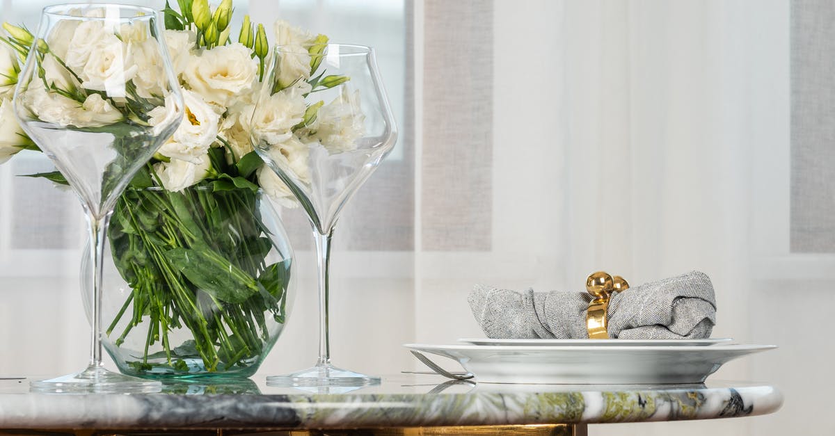 Did the One Ring actually have an influence on Gollum serving Frodo? - Pair of elegant wineglasses and white plate with napkin with golden ring served on marble table with bunch of fresh white lisianthus flowers in vase in modern restaurant