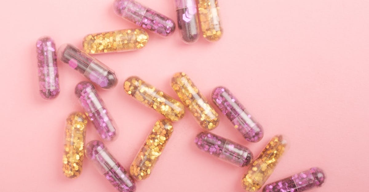 Did they shoot a different ending? - Pile of sparkling drug capsules scattered on pink surface