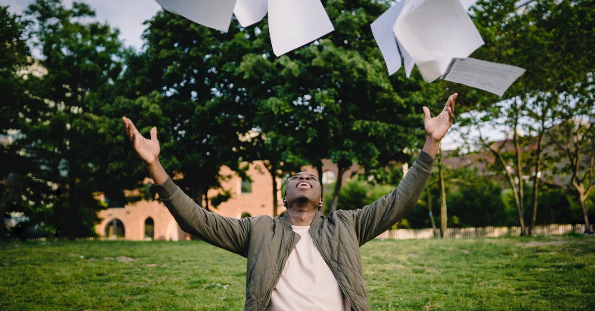 Did Tony post guys outside of Happy's hospital room and have them require badges to get in? - Happy young African American male student in casual outfit tossing university papers in air while having fun in green park after successfully completing academic assignments
