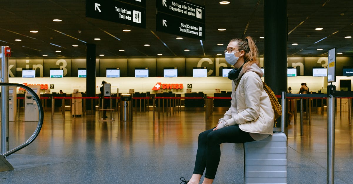 Did V escape before or after the St. Mary's virus event? - Woman Sitting on Luggage