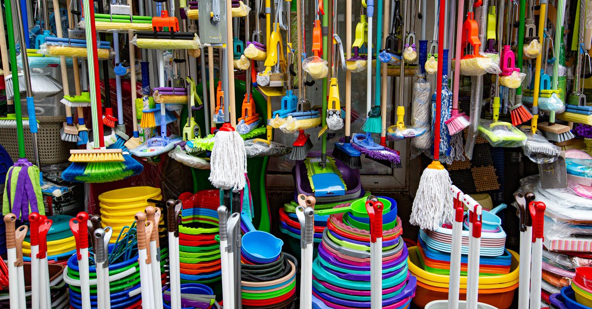 Did Zorba the Greek borrow a section from Don Quixote? - Various colorful mops and brushes arranged with stack of plastic basins and bins in household goods supermarket