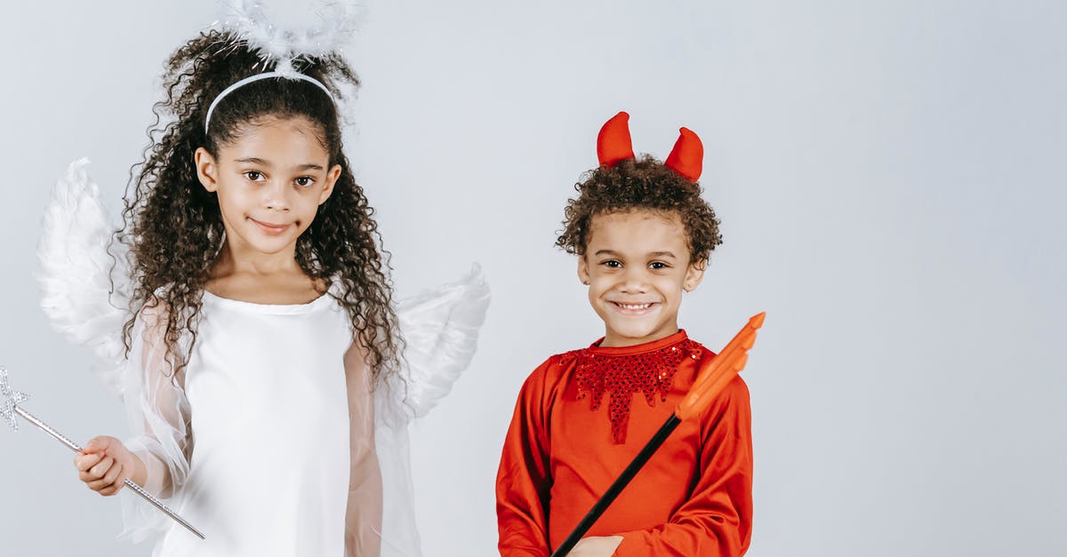 Difference between versions of Carnival of Souls (1962) - Cute little black children in angel and devil costumes smiling at camera in white studio