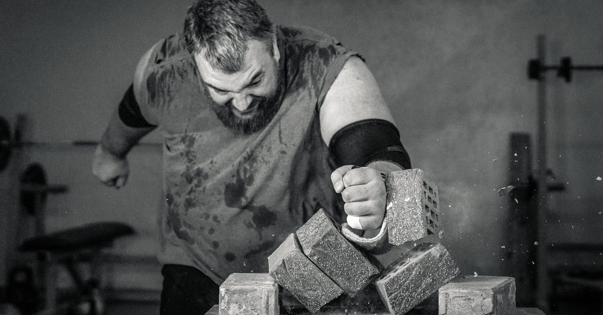 Do King Benny and Fat Man know the whole story? - Grayscale Photography of a Man Hitting the Blocks of Cement on the Table