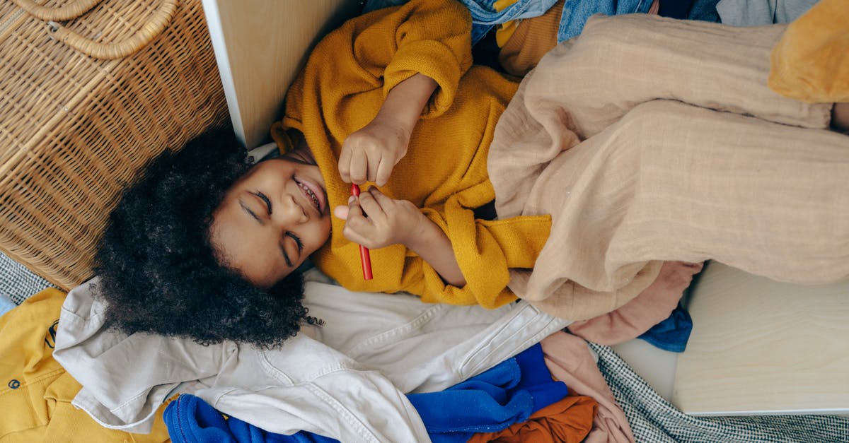 Do the kids from Stranger Things have any analogues to the Dungeons & Dragons game characters? - Top view of funny cute little African American girl lying on pile of scattered clothes and drawing on hand with marker