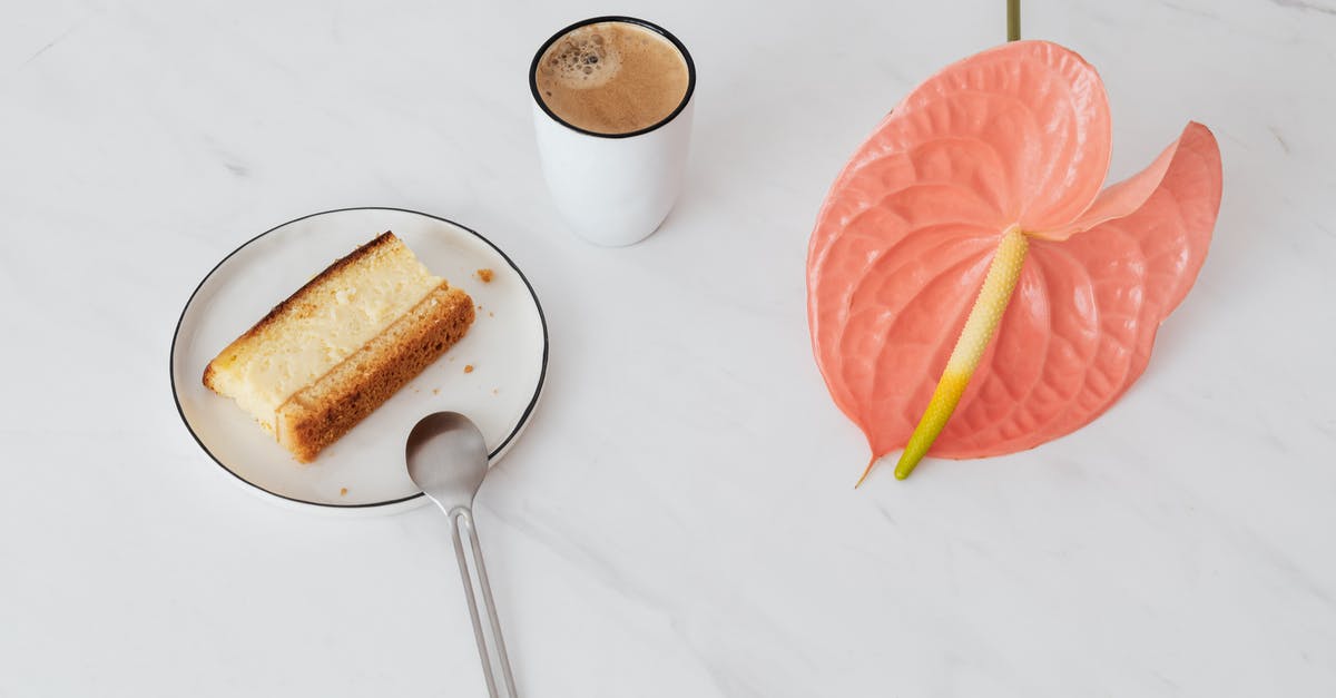 Do they really drink or eat when shooting movies? - From above of pink Anthurium placed near ceramic cup of coffee and  fresh sweet dessert on ceramic plate with spoon on marble surface