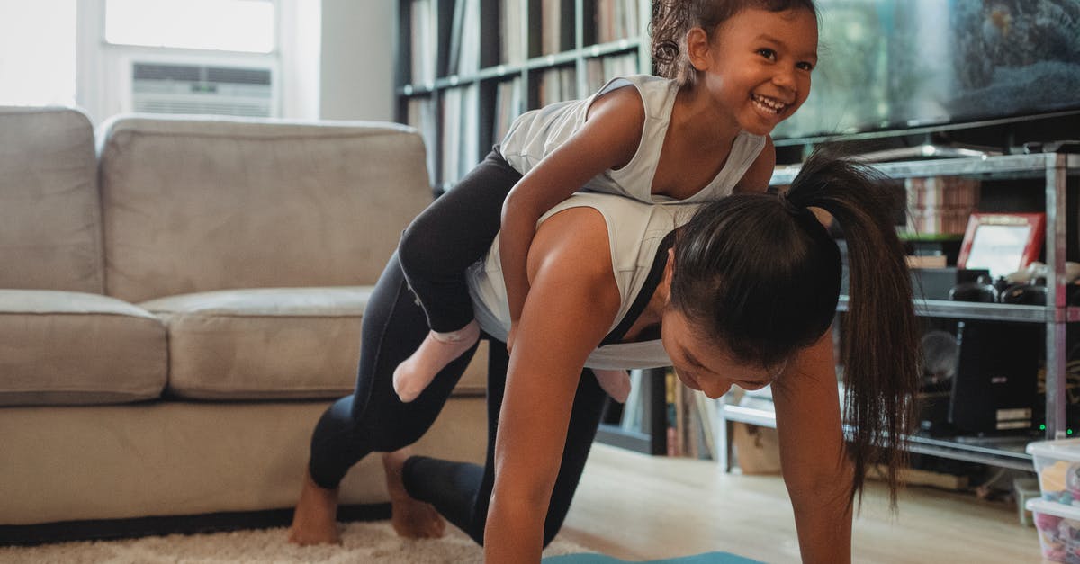 Does #1 have any former training? - Young Asian woman piggybacking smiling daughter while exercising at home