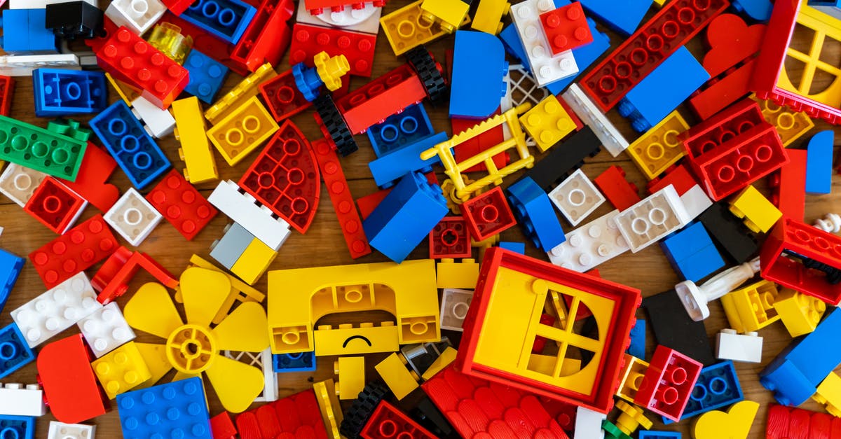 Does Brick Heck from The Middle have Asperger syndrome? - Top view of various pieces of colorful plastic construction toys scattered on wooden floor as abstract background