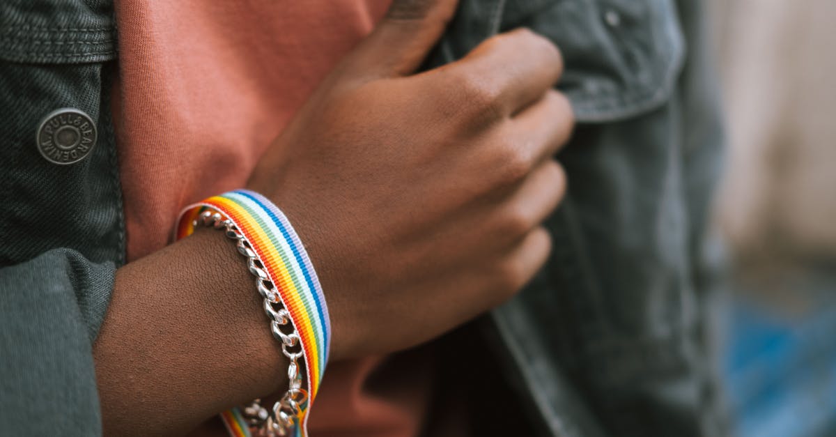 Does Intolerance show the first gay kissing? - Crop black man showing bright fabric bracelet